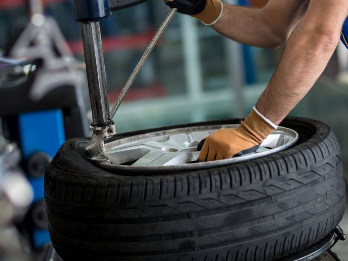 Technician working on a car wheel at New Wheels